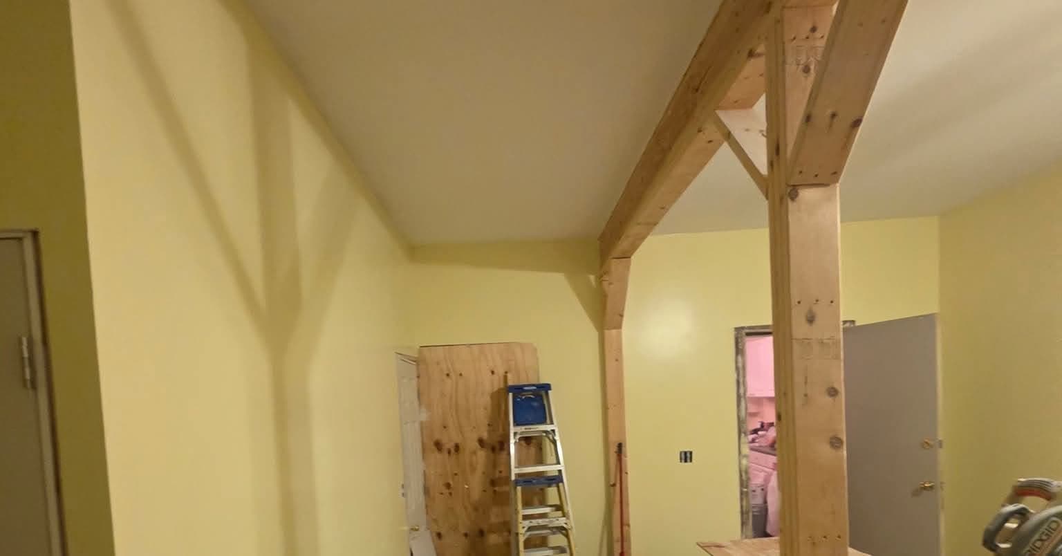 Finished interior with painted walls and exposed timber posts